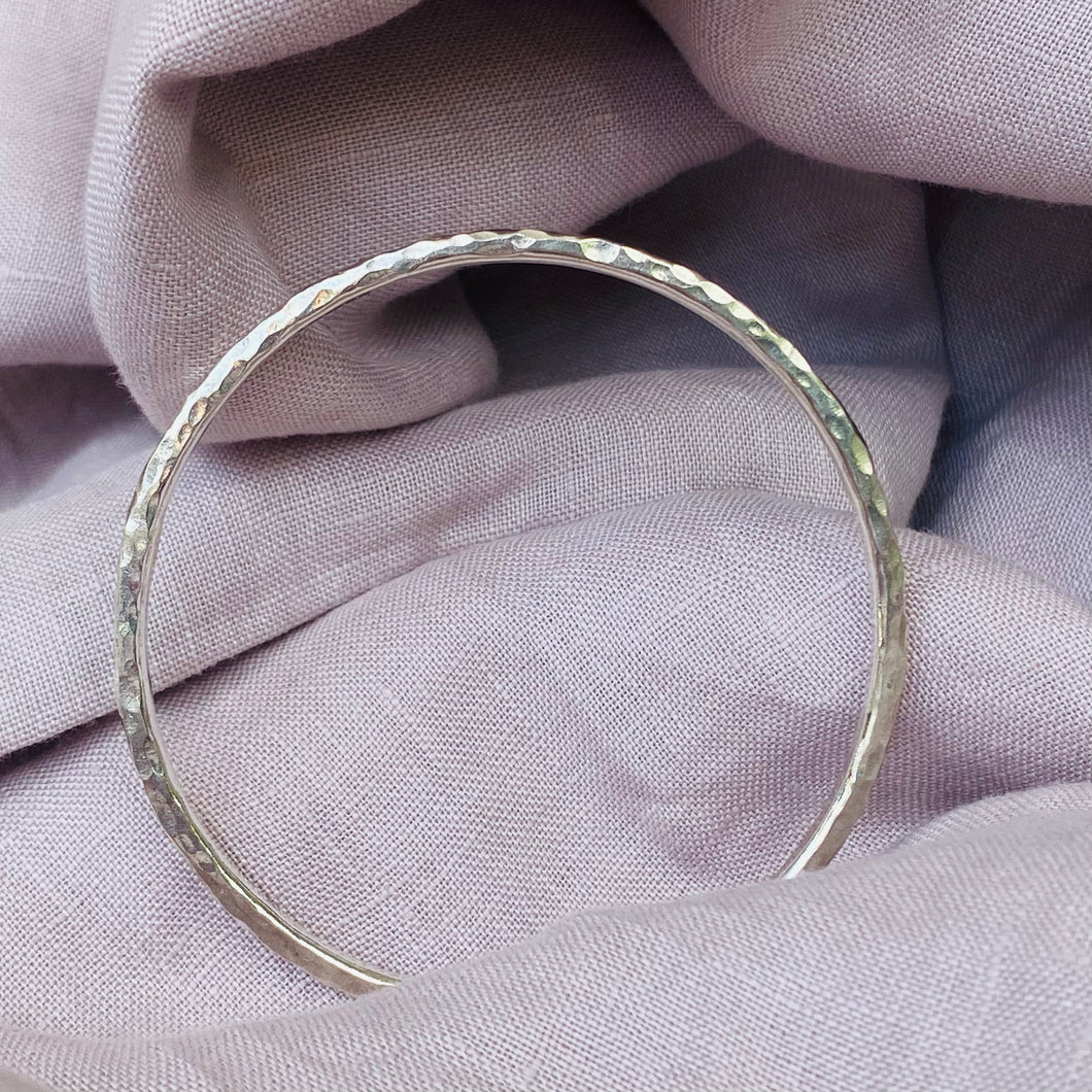 Thick hammered silver bangle